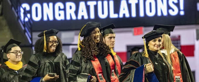 photo of graduates in caps and gowns, regalia